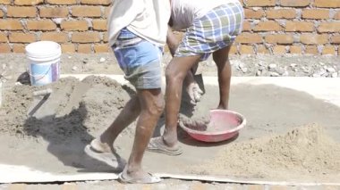 Strength in Unity - Three Men Build with Cement