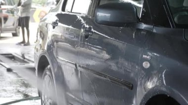 Vehicle Washed with Foamy Water - Close-up of Car's Reflection in Wet Surface