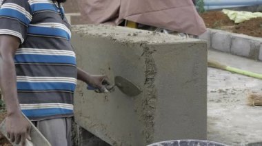 Skilled Craftsman Mixing Cement with Precision