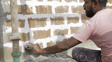Expertly Laying the Foundation - A Master Plasterer at Work