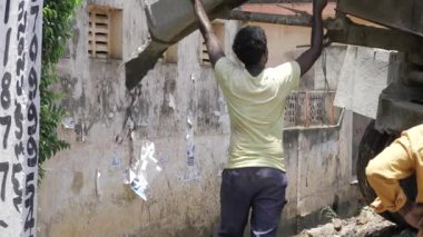 Strong Arm - Manual Lifting in an Urban Alleyway