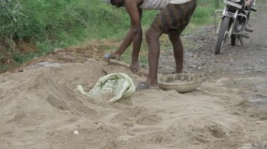 Hard Work in Action - Digging Into the Ground with a Shovel