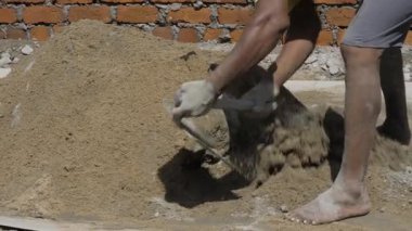 Digging Deep - Expert Hand at Work with Cement