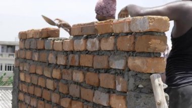 Essential Brickwork in Progress - Skilled Artisans Crafting a Solid Foundation