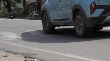 Sleek Blue Electric Car in Motion on City Street