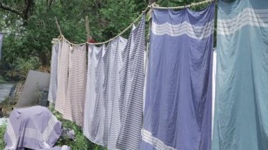 Colorful Towels Drying in the Sun - A Serene Outdoor Scene
