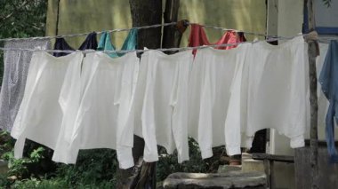Vibrant Laundry Line - A Rainbow of Clothes Drying in the Sun