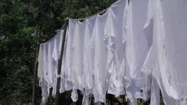 Organic White Cloth Draped on Wooden Rope