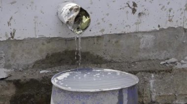 Water Flowing from Hose in Pan