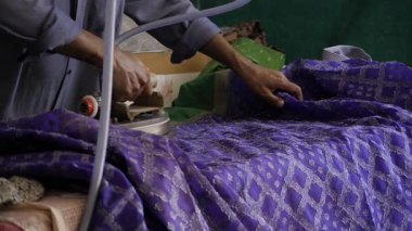 Skilled Craftsman Ironing Fabric with Precision