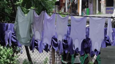 Colorful Clothes Drying on Rope in Sunlight