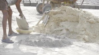 Hardworking Man Digging in Sand, Determined and Focused