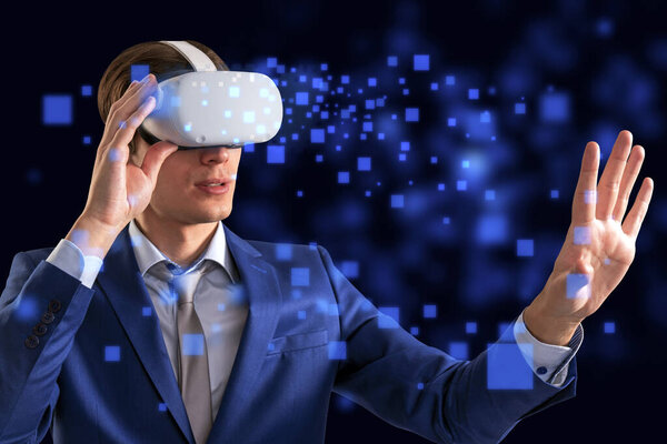 VR and cyberspace concept with man in suit and tie wearing white modern headset with hand touching virtual screen in form of digital blue squares
