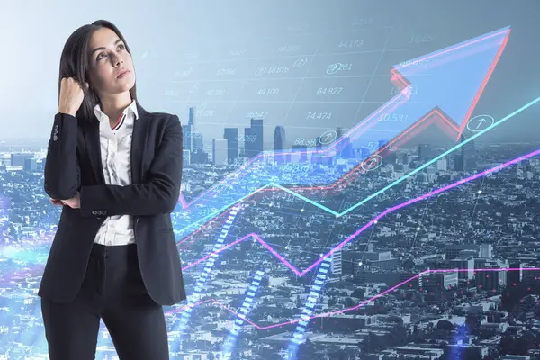 Attractive young european businesswoman with abstract growing business arrow and chart thinking on blurry city background with index grid. FInancial data, trade and market concept. Double exposure