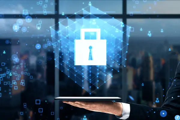 Close up of businessman hand holding tablet with creative glowing blue padlock grid hologram on blurry bokeh background with window frame and city view. Secure, safety and web protection concept
