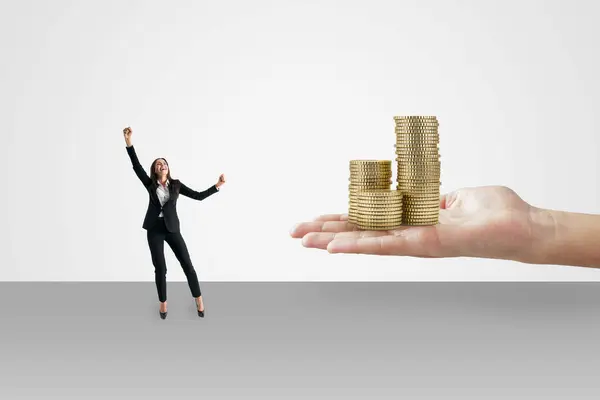 stock image Winning the lottery concept with happy woman in black suit and human palm with golden coin stacks