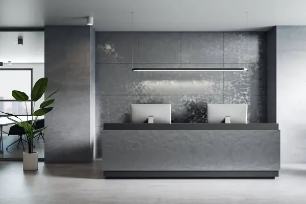 Front view on reception desk in stylish office with modern computers, grey wall decoration and green plant on concrete floor. 3D rendering