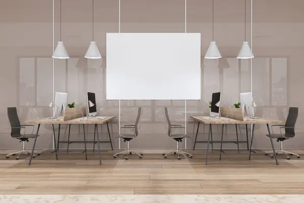 Blank white poster with place for your logo or text on light beige glossy wall in open space office with modern computers on wooden tables and black chairs. 3D rendering, mock up