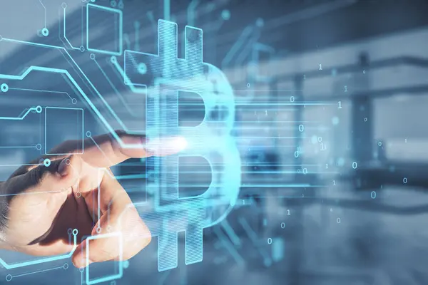 Close up of businessman hand pointing at glowing bitcoin hologram on blurry office interior background. Metaverse, cryptocurrency and crypto concept. Double exposure