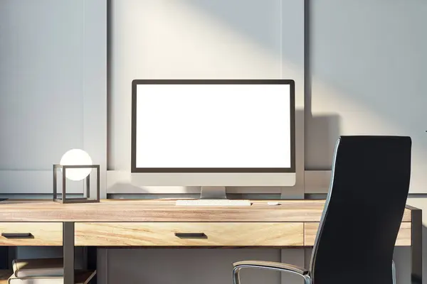 Modern computer monitor on office desk with geometric lamp and minimalist design. Professional workspace concept. 3D Rendering