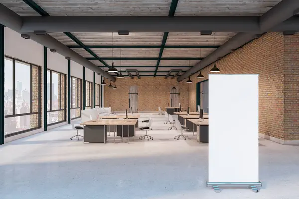Blank white poster with place for your logo or text on concrete floor in open space loft style coworking office with wooden tables and brick walls. 3D rendering, mock up