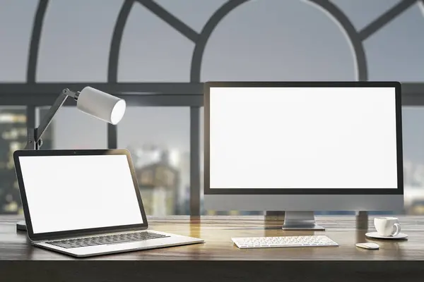 Close up of night designer desk top with empty white laptop computer screens, coffee cup and keyboard on wooden desktop and window with city view background. Mock up, 3D Rendering