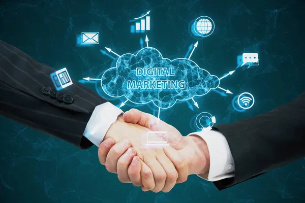Close up of handshake with creative blue polygonal cloud digital marketing hologram with icons on blurry background. Strategy and business concept