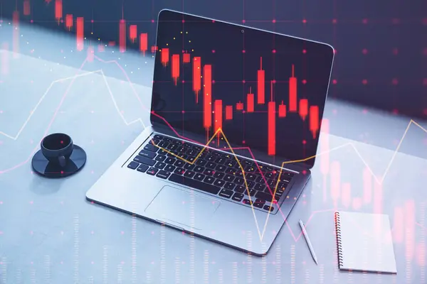 Close up of laptop on desktop with coffee cup, notepad and falling red forex hologram on blurry background. Stock crisis price drop down chart fall / Stock market exchange analysis or forex graph business and finance money losing moving economic infl