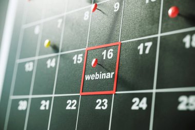 Closeup of a calendar showing a pinned event on the 16th, marked as webinar. The background is a black wall. Concept of event planning. 3D Rendering clipart