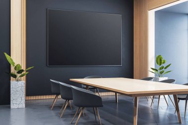 Modern ofis içindeki karanlık duvarda boş siyah çerçeve modeli. Ahşap masa, siyah sandalyeler ve bitkilerle. 3B Hazırlama