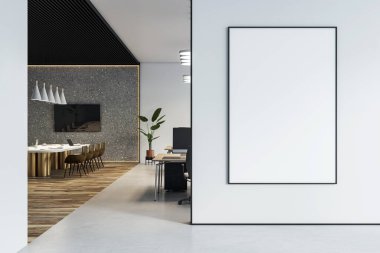 Modern ofis içinde beyaz duvarda dikey boş poster çerçevesi, çalışma istasyonları ve toplantı alanı ile temiz tasarım içeriyor. 3B Hazırlama