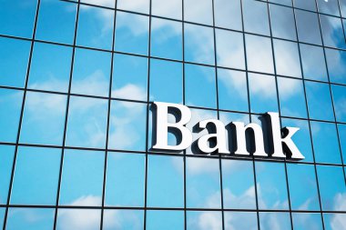 Binanın üzerinde bir banka tabelası var. Tabela beyaz ve üzerinde 