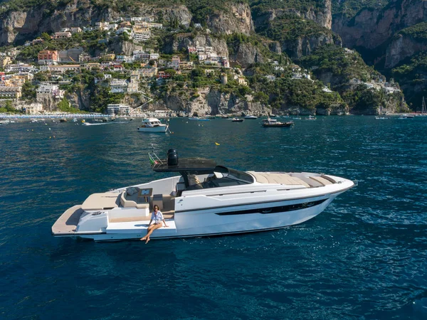 stock image aerial view Young woman on a yacht in the amalfi coast, positano, italy