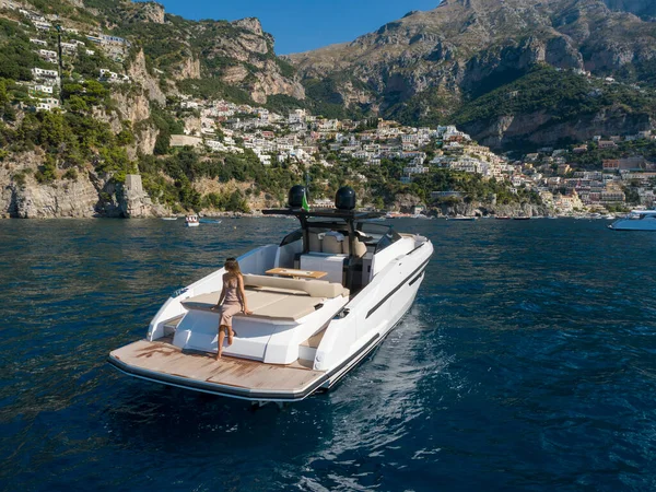 stock image aerial view Young woman on a yacht in the amalfi coast, positano, italy