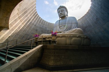 Hill of the Buddha, a Buddhist shrine features a 13.5m (44ft) tall statue of the Buddha encircled by an artificial hill, at Makomanai Takino Cemetery in Takino Suzuran Hillside Park , Sapporo, Hokkaido, Japan clipart