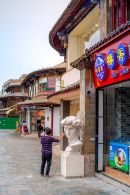 Kunming, Yunnan, China - July 1, 2024 - Scene of Guandu Ancient Town, one of the main historical and cultural landscape of Kunming tourism with a large market and important transportation hub clipart