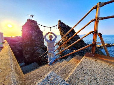 Meoto Iwa, or Married Couple Rocks, the couple rocks represent as the wedded couple in the Nomozaki area, the southern part of Nagasaki city in Kyushu, Japan clipart