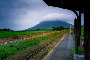 Kagoshima, Kyushu, Japan - November 16, 2024 - Scene of JR Nishi Oyama Station, the southernmost of JR station with background of the Kaimondake, a volcano located near the city of Ibusuki in the south of Kagoshima clipart