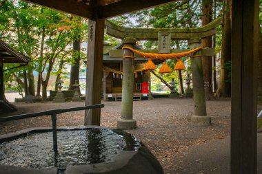 Yufuin, Oita, Kyushu, Japan - November 21, 2024 - Scene of Tenso shrine on the bank of Kinrin lake, one of the popular spot to see view of the lake clipart