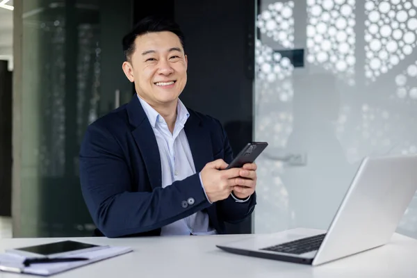 Happy Asian Man Using Phone Office Businessman Smiling Looking Camera — Stockfoto