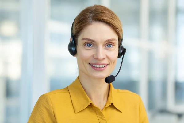 stock image Portrait of successful smiling business woman with headset phone, mature experienced worker smiling and looking at camera, video call online meeting, online customer support service.