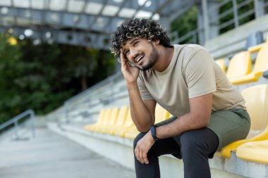 Yorgun adam yorucu bir eğitimden sonra dinleniyor, aktif fiziksel egzersizler ve spor yapıyor. Sporcunun şiddetli bir baş ağrısı var..