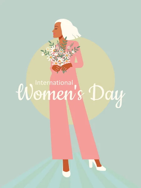 International Women\'s Day. A beautiful fashionable blonde in a pink jumpsuit stands in full growth with a bouquet of daisies. Vertical light blue banner.