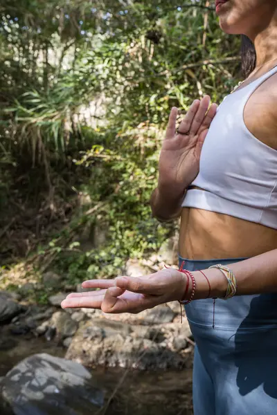 woman doing yoga pose in the river