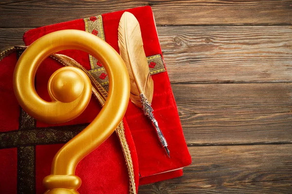 6th december Saint Nicholas Day - Sinterklaas. St Nicholas mitre and book on wooen table.