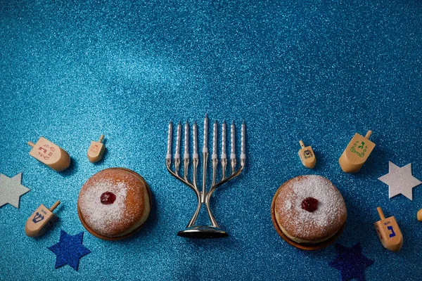Jewish holiday Hanukkah background with menorah and dreidel with letters Gimel and Nun