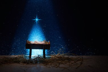 Nativity of Jesus, empty manger at night with bright lights clipart