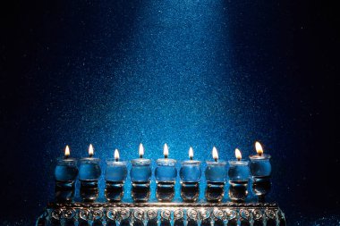 Jewish holiday Hanukkah background with menorah -traditional candelabra and candles. clipart