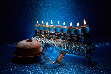 Jewish holiday Hanukkah background with menorah and dreidel with letters Gimel and Nun clipart