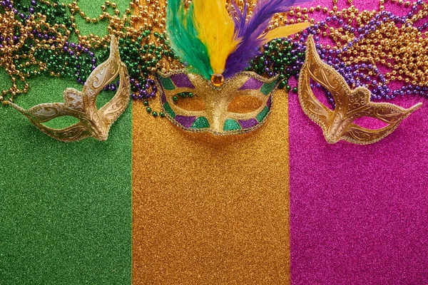 Mardi gras, Venetian or Carnivale mask on on a tricolor shining background. High quality photo